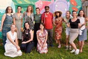 LEAF staff members posing next to a colourful mural(© 2019 Alan Li / LEAF)