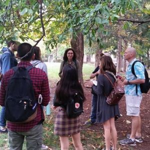 Woman speaking to a crowd under a tree(© 2019 Sammy Tangir)