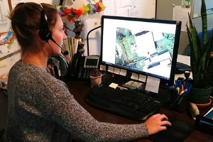 LEAF staff at their desk, a map is visible on the computer screen(© 2019 Daniela Serodio / LEAF)