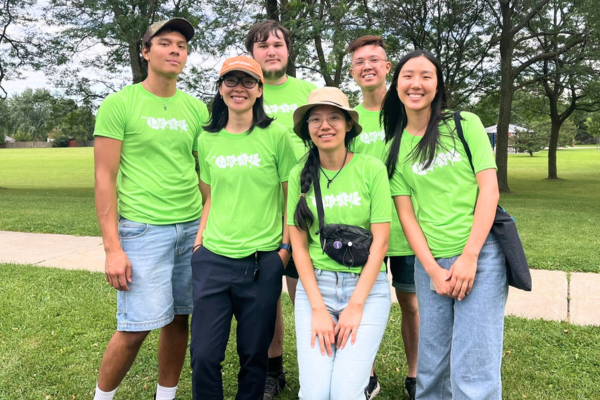 Six YUFL participants in green LEAF shirts pose and smile after finishing their tree tours at Dorset Park. 