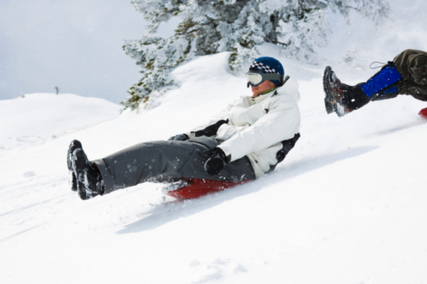 tobogganing in the slow is a fun outdoor activity