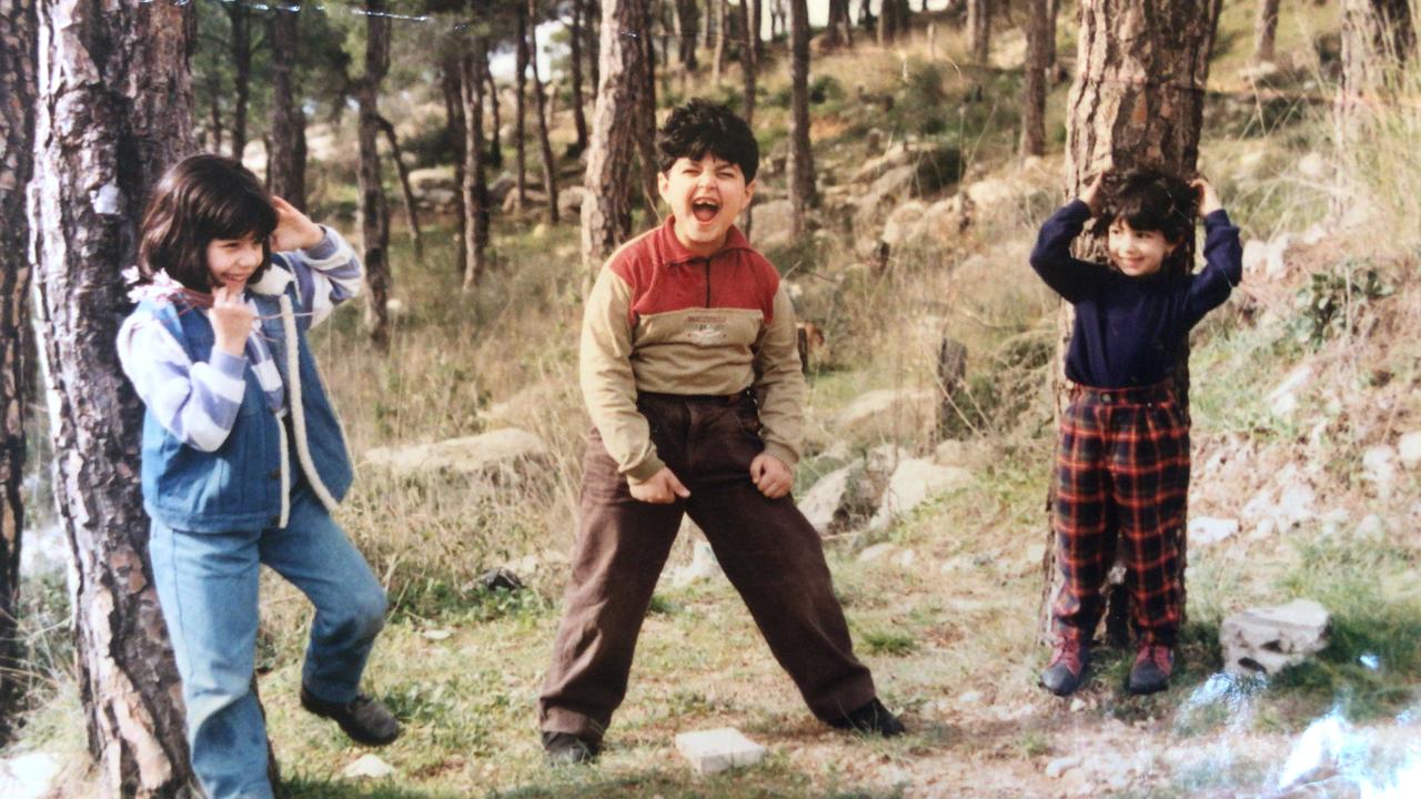 Lynn and her siblings with the very stone pines her dad climbed(© 1999 Mahmoud Charafeddine)