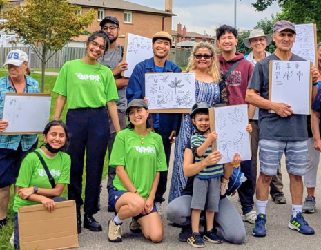 YUFLs at a tree tour event with community members holding tree sketches