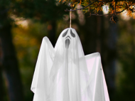 ghost decoration hanging from tree